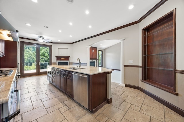 4452 Plumberry Rd, Ely, IA 52227 - kitchen with stainless steel appliances, stone tile floors, ceiling fan, ornate columns, and ornamental molding