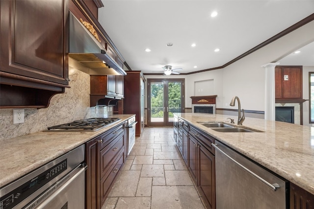 4452 Plumberry Rd, Ely, IA 52227 - kitchen with stainless steel appliances, a fireplace, stone tile floors, recessed lighting, and a ceiling fan
