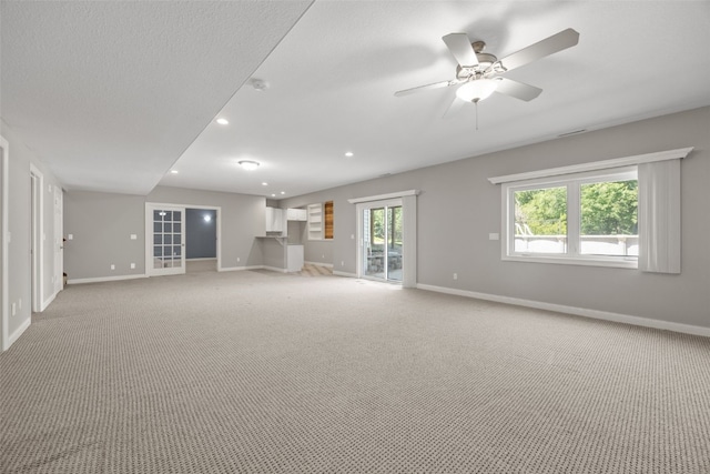 4452 Plumberry Rd, Ely, IA 52227 - unfurnished living room with light carpet, recessed lighting, and a ceiling fan