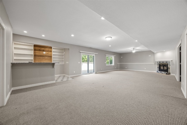 4452 Plumberry Rd, Ely, IA 52227 - unfurnished living room with a fireplace, light carpet, ceiling fan, and recessed lighting