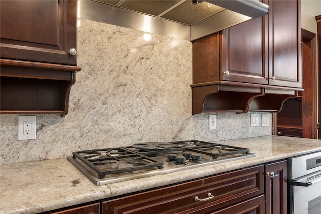 4452 Plumberry Rd, Ely, IA 52227 - kitchen featuring appliances with stainless steel finishes, decorative backsplash, dark brown cabinetry, and wall chimney exhaust hood