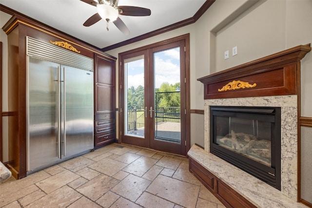 4452 Plumberry Rd, Ely, IA 52227 - entryway featuring french doors, stone tile flooring, ornamental molding, a ceiling fan, and a premium fireplace