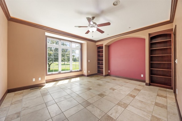 4452 Plumberry Rd, Ely, IA 52227 - spare room with built in features, crown molding, ceiling fan, light tile patterned floors, and arched walkways