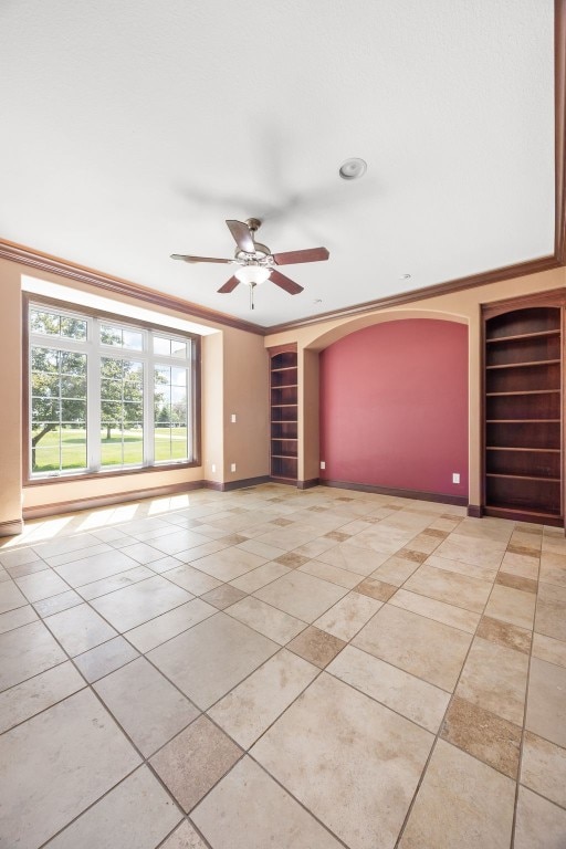 4452 Plumberry Rd, Ely, IA 52227 - unfurnished room featuring built in shelves, light tile patterned floors, ceiling fan, and crown molding
