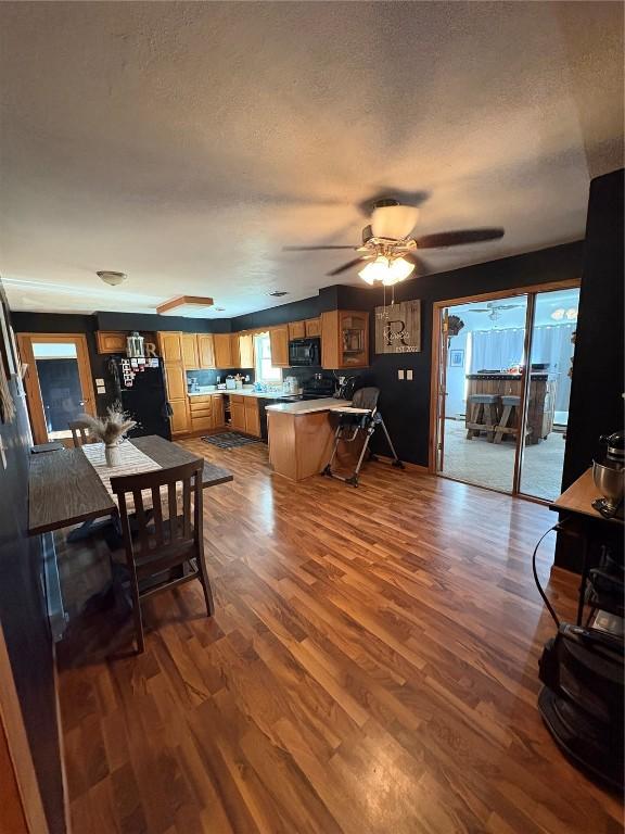 21 Mill St, Walker, IA 52352 - dining area featuring wood finished floors, a textured ceiling, and ceiling fan