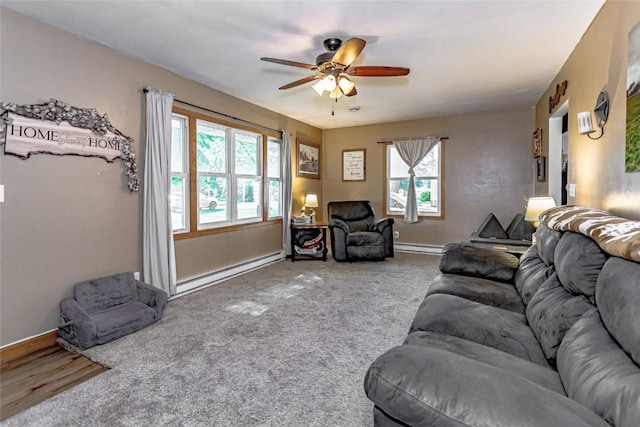 21 Mill St, Walker, IA 52352 - carpeted living area with a baseboard heating unit and a ceiling fan