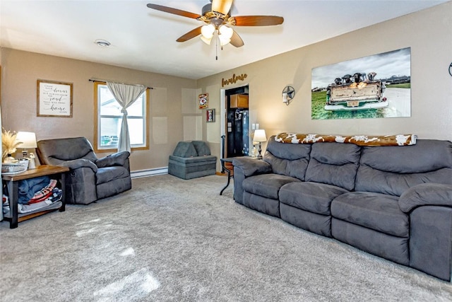 21 Mill St, Walker, IA 52352 - living room featuring a baseboard heating unit, carpet floors, and a ceiling fan
