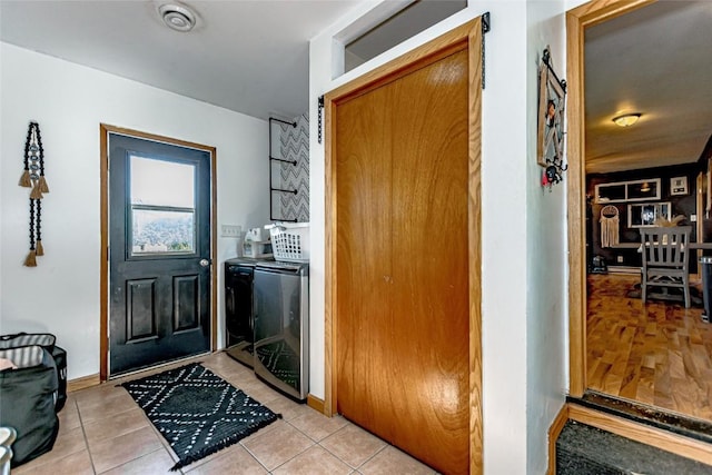 21 Mill St, Walker, IA 52352 - laundry room with independent washer and dryer and light tile patterned flooring
