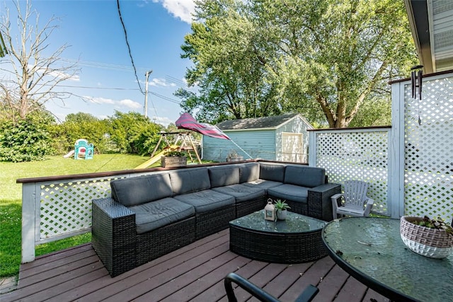 21 Mill St, Walker, IA 52352 - deck with a playground, a shed, an outdoor hangout area, and a lawn