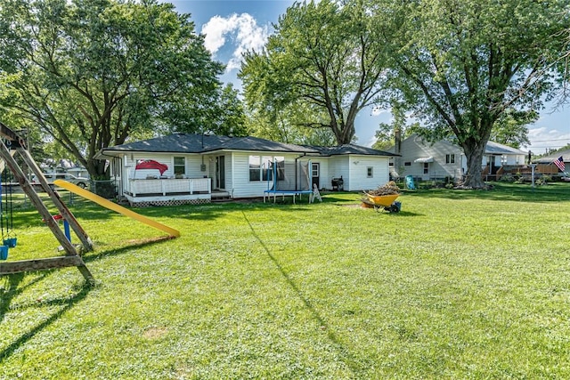 21 Mill St, Walker, IA 52352 - back of house with a trampoline and a deck