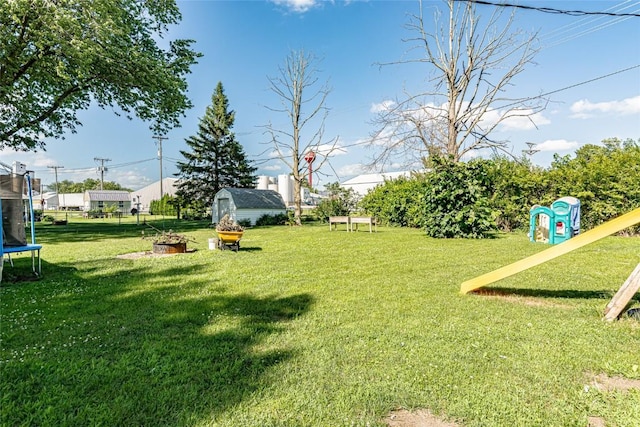 21 Mill St, Walker, IA 52352 - view of grassy yard with a trampoline and a shed