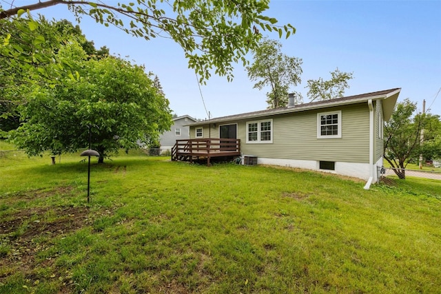 1642 19th St, Cedar Rapids, IA 52405 - rear view of property with a wooden deck and a yard