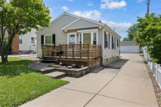 913 32nd St SE, Cedar Rapids, IA 52403 - view of front of house featuring a detached garage, an outbuilding, and a deck