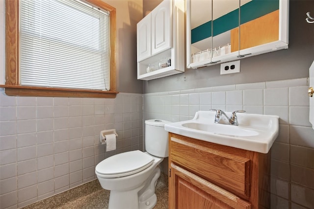 913 32nd St SE, Cedar Rapids, IA 52403 - bathroom featuring tile walls, healthy amount of natural light, vanity, a wainscoted wall, and a shower with shower curtain