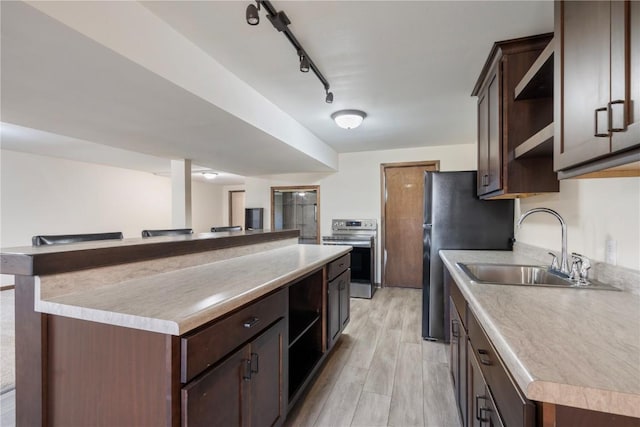 6752 29th Ave, Shellsburg, IA 52332 - kitchen with open shelves, stainless steel appliances, dark brown cabinetry, and light wood-style flooring
