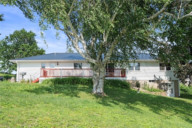 6752 29th Ave, Shellsburg, IA 52332 - back of house featuring a metal roof, a wooden deck, and a yard