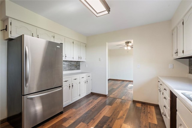 6752 29th Ave, Shellsburg, IA 52332 - kitchen with freestanding refrigerator, dark wood-type flooring, white cabinetry, and light countertops