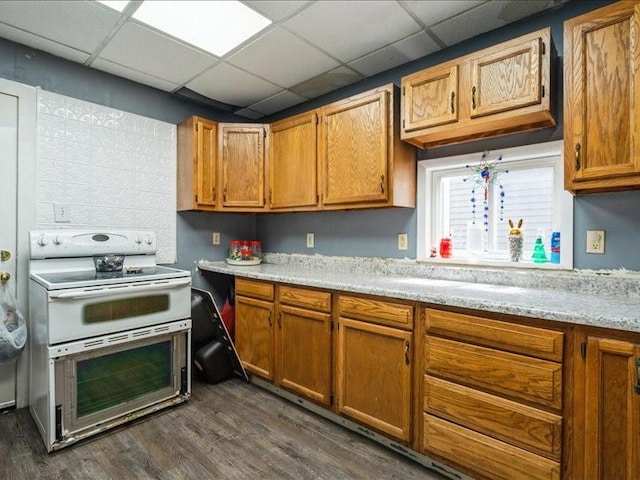 1551 C Ave NE, Cedar Rapids, IA 52402 - kitchen featuring range with two ovens, dark wood-type flooring, and brown cabinetry