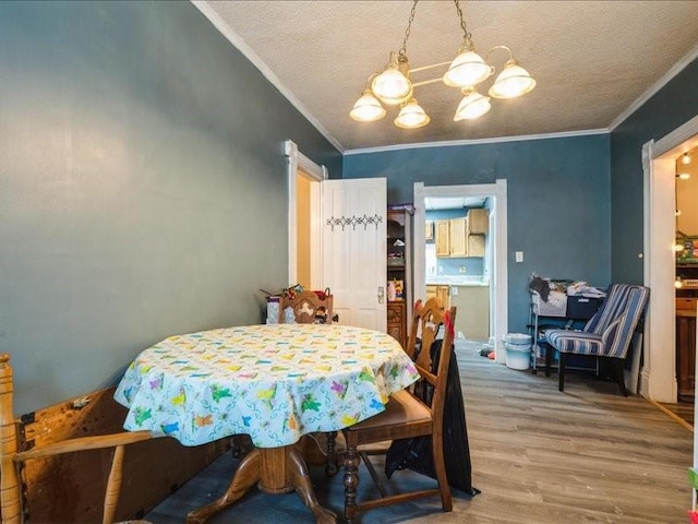 1551 C Ave NE, Cedar Rapids, IA 52402 - dining area featuring ornamental molding, wood finished floors, a chandelier, and a textured ceiling