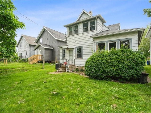 1551 C Ave NE, Cedar Rapids, IA 52402 - back of property featuring a yard and a chimney