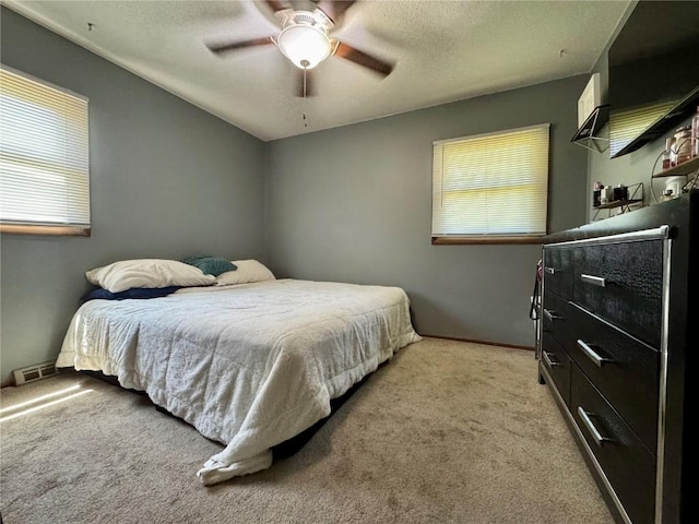 72 Fleetwood Rd NW, Cedar Rapids, IA 52405 - bedroom with carpet, ceiling fan, and a textured ceiling
