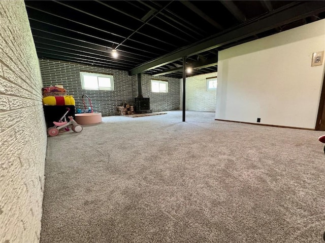 72 Fleetwood Rd NW, Cedar Rapids, IA 52405 - basement with a wood stove, plenty of natural light, and carpet floors