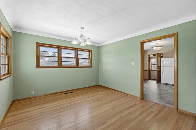 340 18th St NW, Cedar Rapids, IA 52405 - spare room with a chandelier, healthy amount of natural light, and light wood finished floors