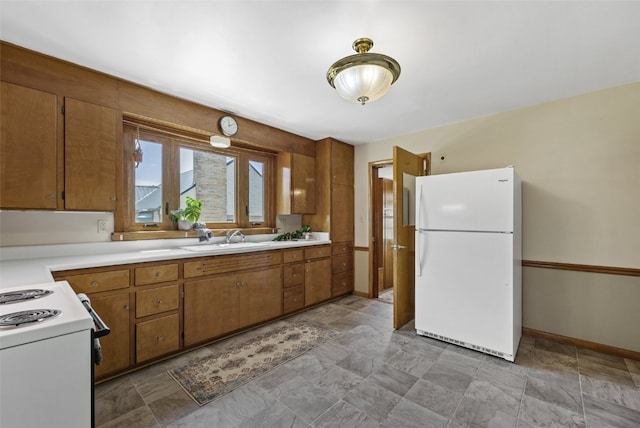 340 18th St NW, Cedar Rapids, IA 52405 - kitchen featuring white appliances, brown cabinets, light countertops, and stone finish flooring