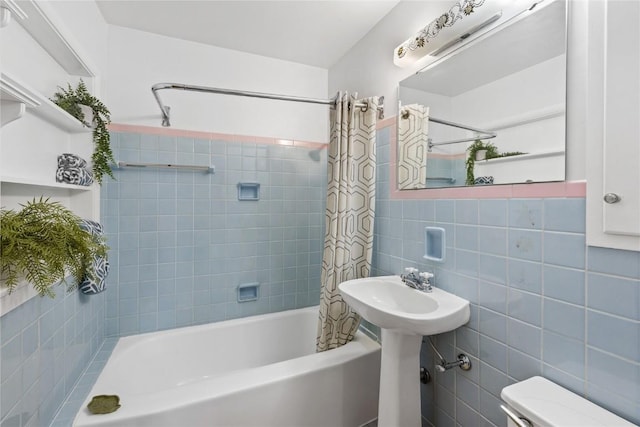 340 18th St NW, Cedar Rapids, IA 52405 - bathroom featuring tile walls and shower / tub combo with curtain