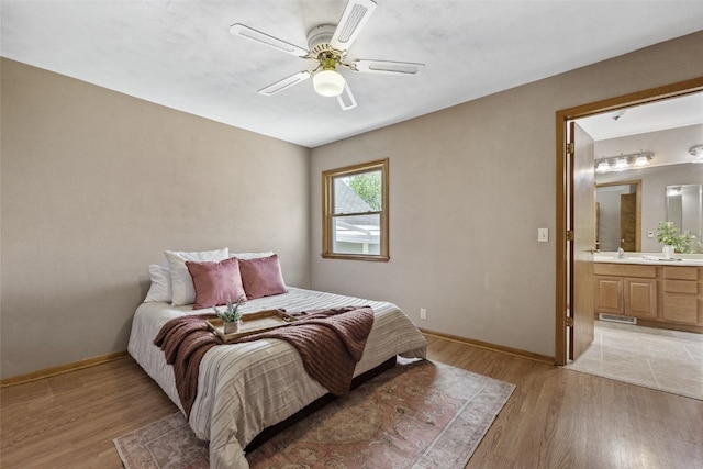 340 18th St NW, Cedar Rapids, IA 52405 - bedroom featuring light wood-style flooring, ensuite bath, and a ceiling fan