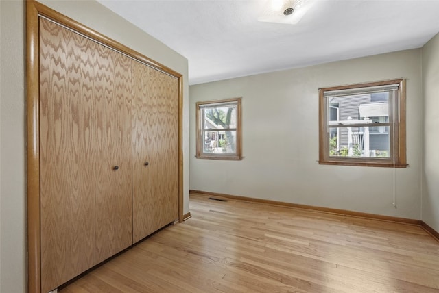 340 18th St NW, Cedar Rapids, IA 52405 - unfurnished bedroom featuring a closet and light wood-type flooring