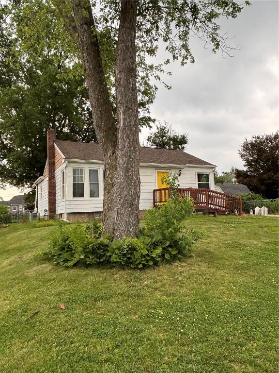 143 21st St SW, Cedar Rapids, IA 52404 - rear view of property with a deck and a chimney