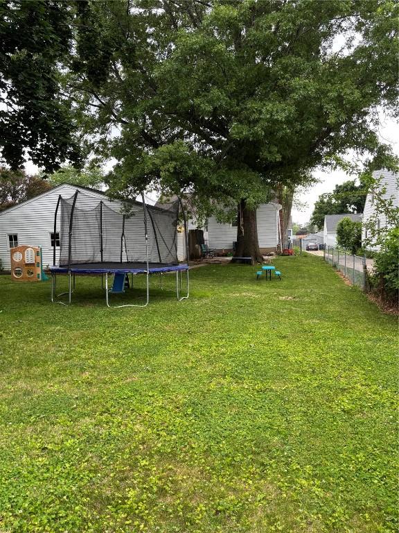 143 21st St SW, Cedar Rapids, IA 52404 - view of yard featuring a trampoline