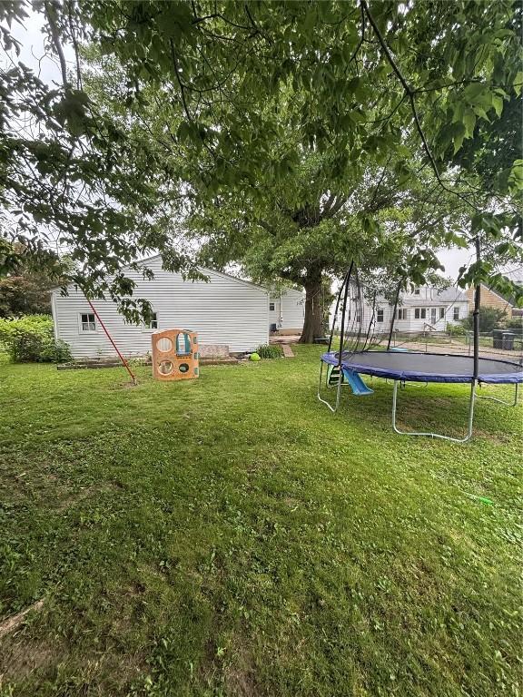 143 21st St SW, Cedar Rapids, IA 52404 - view of green lawn with a trampoline