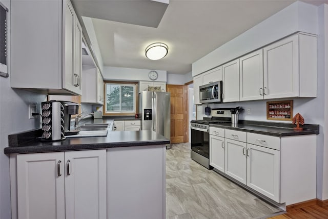 7812 Wieneke Cir, Cedar Rapids, IA 52404 - kitchen featuring stainless steel appliances, a peninsula, and white cabinets