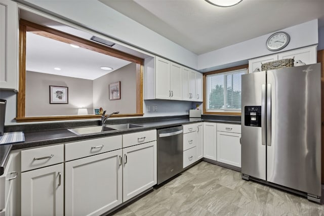 7812 Wieneke Cir, Cedar Rapids, IA 52404 - kitchen featuring appliances with stainless steel finishes, light marble finish floors, white cabinets, and dark countertops