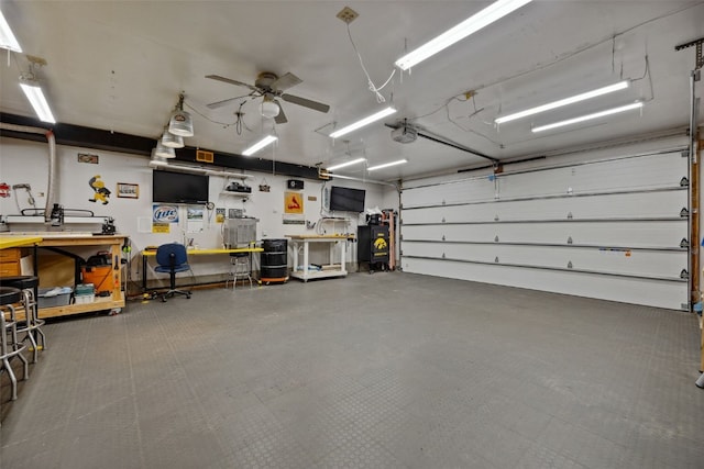 7812 Wieneke Cir, Cedar Rapids, IA 52404 - garage with a workshop area, a garage door opener, and a ceiling fan