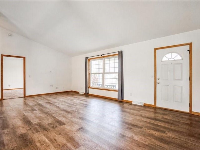 3182 62nd St, Shellsburg, IA 52332 - unfurnished living room featuring wood finished floors and vaulted ceiling