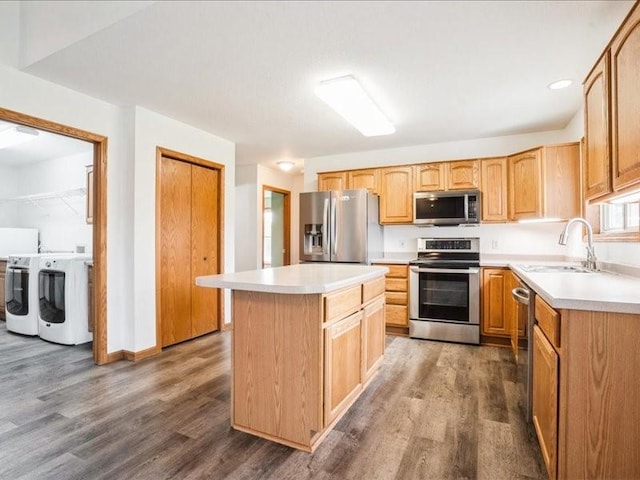3182 62nd St, Shellsburg, IA 52332 - kitchen with appliances with stainless steel finishes, washing machine and clothes dryer, dark wood-type flooring, and light countertops