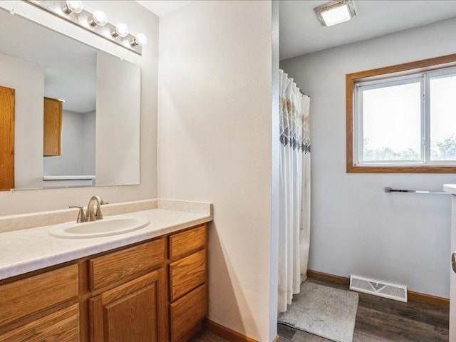 3182 62nd St, Shellsburg, IA 52332 - full bath with vanity, wood finished floors, and a shower with curtain