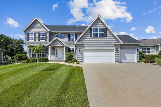 7603 Hampshire Dr NE, Cedar Rapids, IA 52402 - view of front of property featuring concrete driveway, a front lawn, and a garage