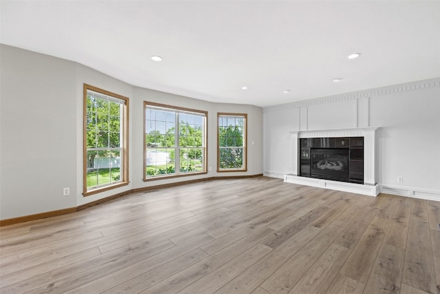 7603 Hampshire Dr NE, Cedar Rapids, IA 52402 - unfurnished living room with light wood-style floors, a fireplace, and recessed lighting