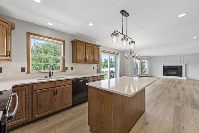 7603 Hampshire Dr NE, Cedar Rapids, IA 52402 - kitchen with dishwasher, range, a kitchen island, recessed lighting, and brown cabinets
