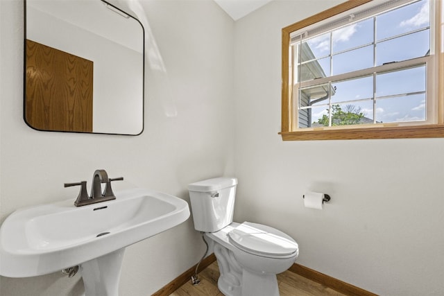 7603 Hampshire Dr NE, Cedar Rapids, IA 52402 - half bathroom with baseboards and wood finished floors