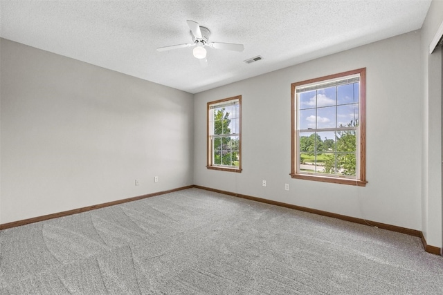 7603 Hampshire Dr NE, Cedar Rapids, IA 52402 - unfurnished room with light carpet, a ceiling fan, and a textured ceiling