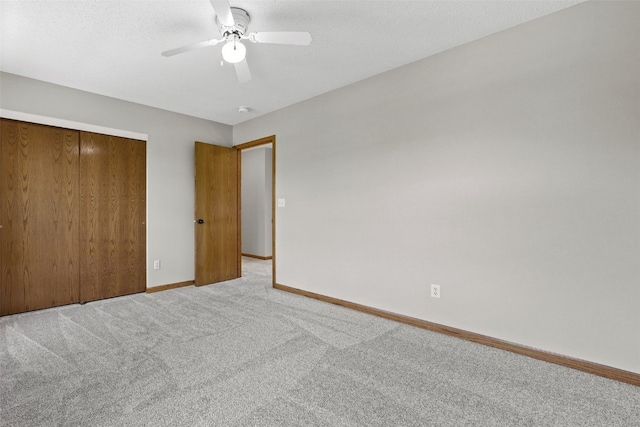 7603 Hampshire Dr NE, Cedar Rapids, IA 52402 - unfurnished bedroom with carpet, a closet, and ceiling fan