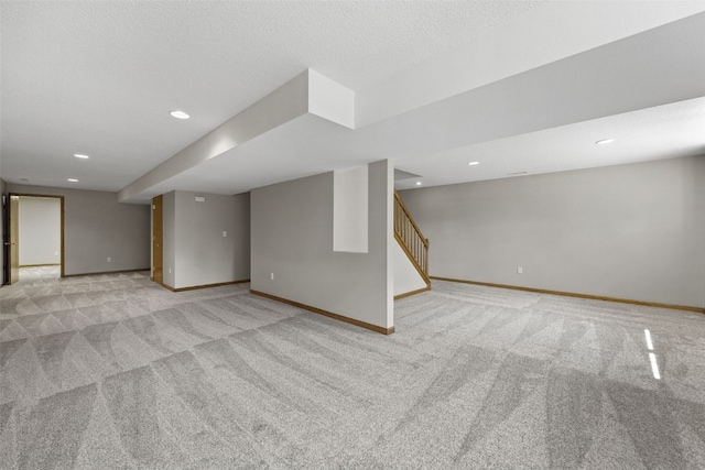 7603 Hampshire Dr NE, Cedar Rapids, IA 52402 - finished basement with light colored carpet, recessed lighting, and stairway