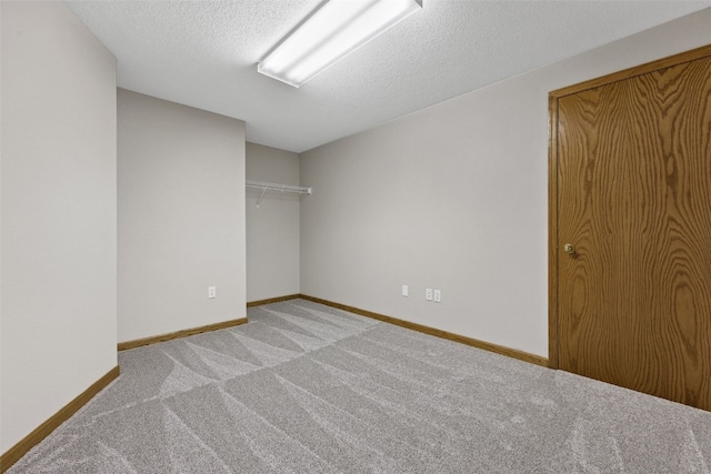 7603 Hampshire Dr NE, Cedar Rapids, IA 52402 - unfurnished bedroom with light colored carpet and a textured ceiling
