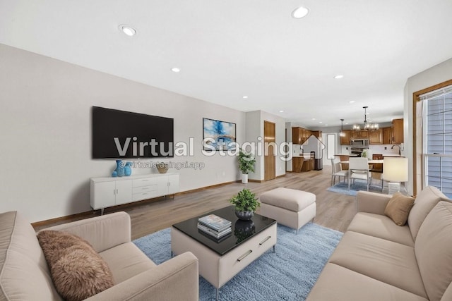 7603 Hampshire Dr NE, Cedar Rapids, IA 52402 - living room featuring a chandelier, light wood finished floors, recessed lighting, and healthy amount of natural light