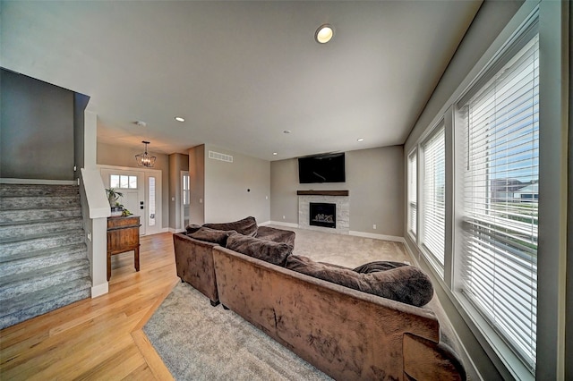 509 Grey Slate Dr SW, Cedar Rapids, IA 52404 - living area with healthy amount of natural light, stairs, a fireplace, light wood-style flooring, and recessed lighting